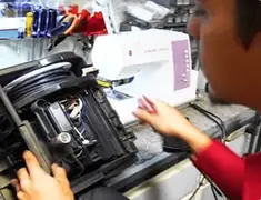 Vacuum repair technician servicing internal components on a workbench in Salt Lake City, UT