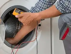 Washing machine repair technician testing a front-load washer with diagnostic tools in Salt Lake City, UT